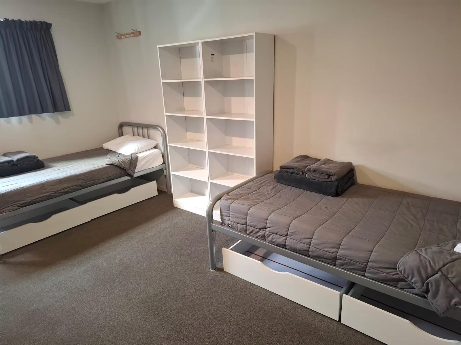 Comfortable bedroom with 2 single beds at RSE Group